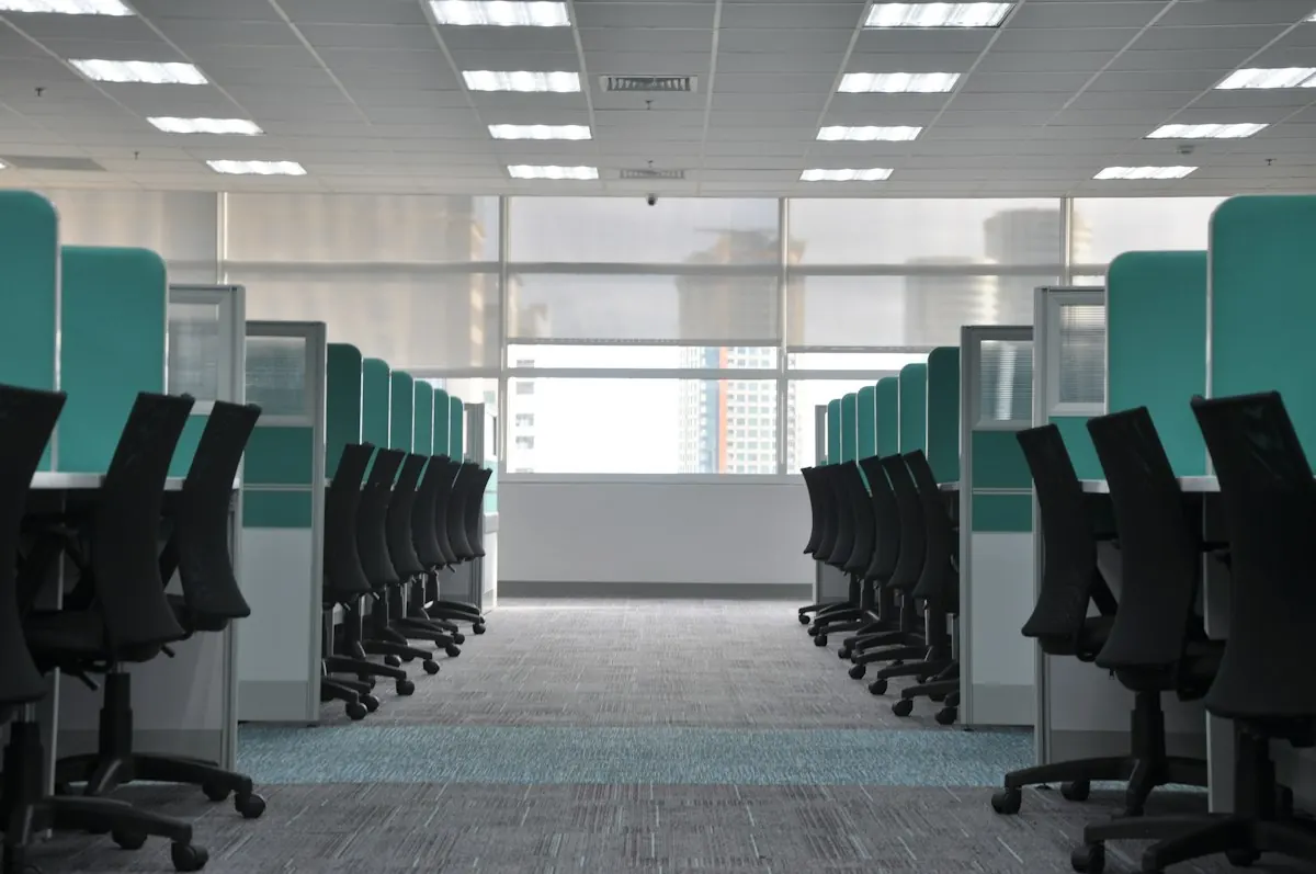 Clean grey carpet running between office cubicles