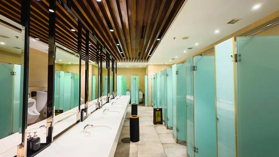 Commercial restroom with sinks, mirrors and stalls