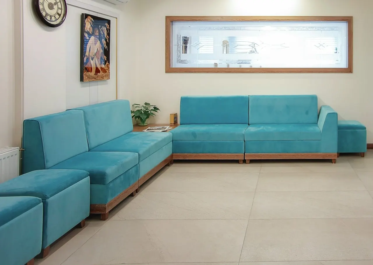 Teal fabric sofas in a clean waiting room
